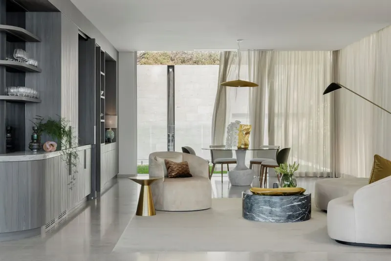 Living room with curved joinery and sculptural furniture