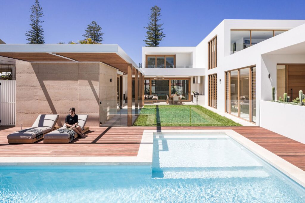 Pool in front of custom home at night